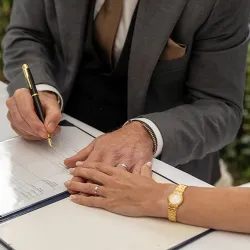 A man and woman filling out marriage applications